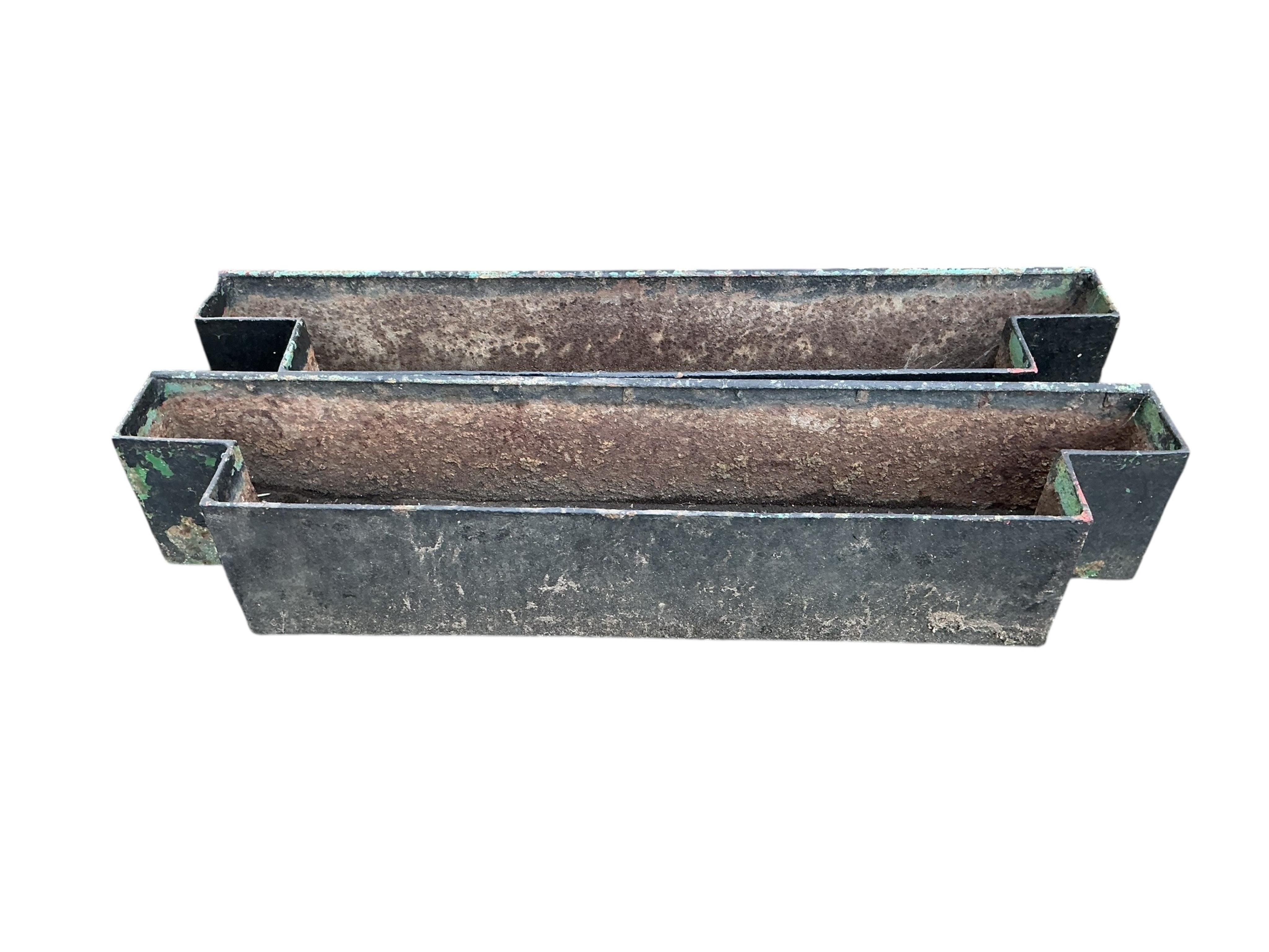 A pair of cast iron planters, width 143cm, depth 28cm, height 26cm